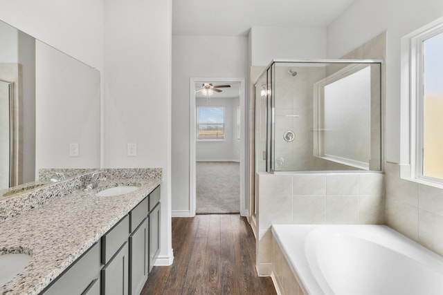 bathroom with ceiling fan, double vanity, independent shower and bath, and hardwood / wood-style flooring