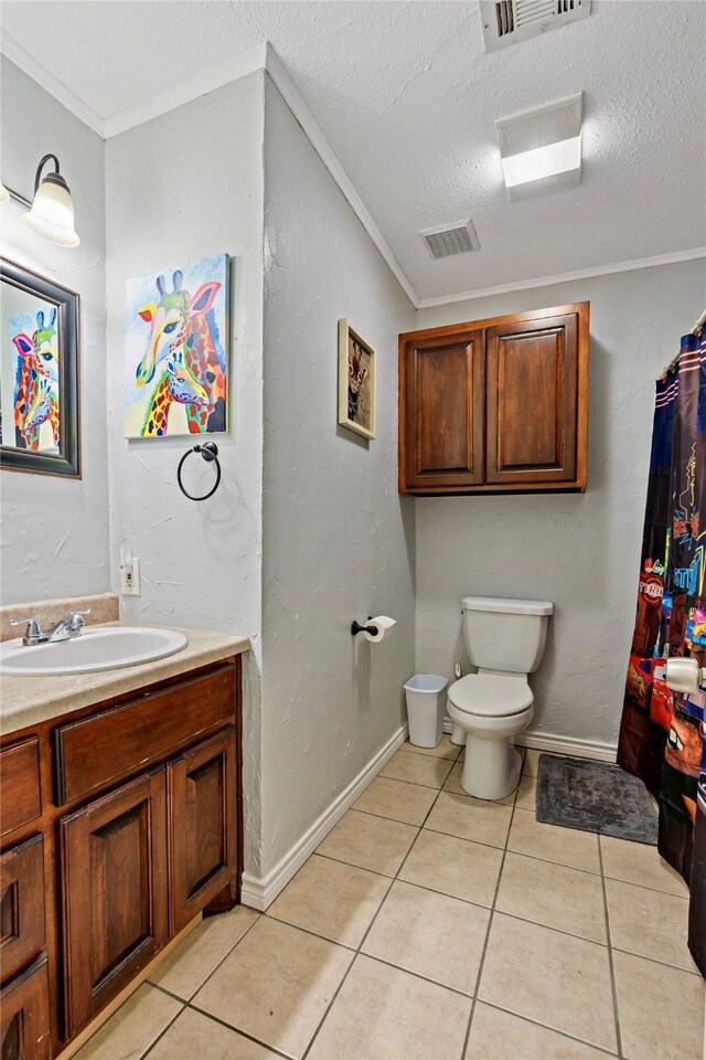 bathroom featuring toilet, a textured ceiling, tile patterned floors, and vanity