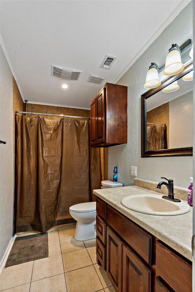 bathroom with toilet, vanity, tile patterned flooring, and visible vents