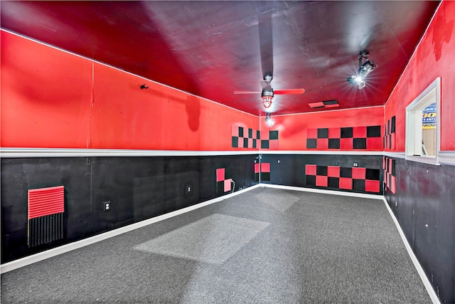 interior space with wainscoting, visible vents, ceiling fan, and baseboards