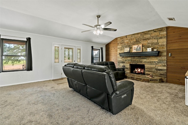 carpeted living room with a wealth of natural light, lofted ceiling, and visible vents