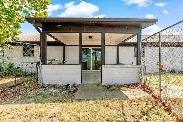 back of property featuring brick siding