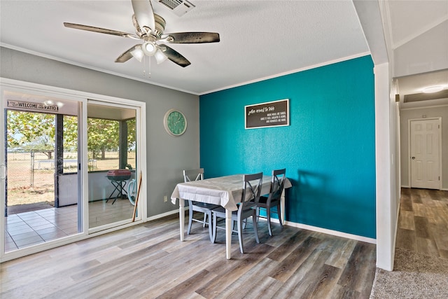 dining space featuring a textured ceiling, ceiling fan, hardwood / wood-style floors, and ornamental molding