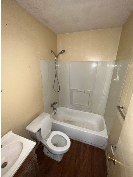 full bathroom with shower / washtub combination, toilet, vanity, and wood-type flooring