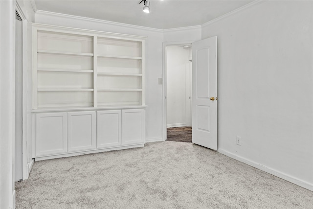 unfurnished bedroom with baseboards, carpet floors, and ornamental molding