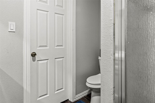 bathroom featuring wood finished floors, vanity, and a textured wall