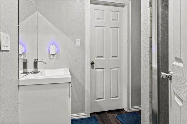 bathroom with vanity and a textured wall