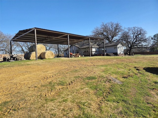 exterior space featuring a detached carport and an outdoor structure