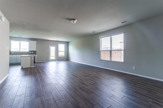 unfurnished living room featuring dark hardwood / wood-style floors