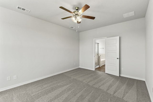 spare room with dark colored carpet and ceiling fan