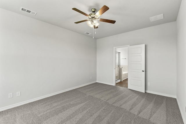 unfurnished bedroom featuring baseboards, visible vents, and dark colored carpet