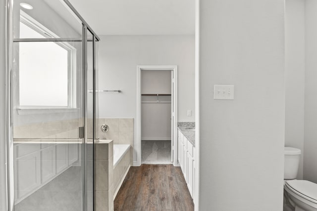 full bathroom featuring plenty of natural light, vanity, hardwood / wood-style floors, and toilet