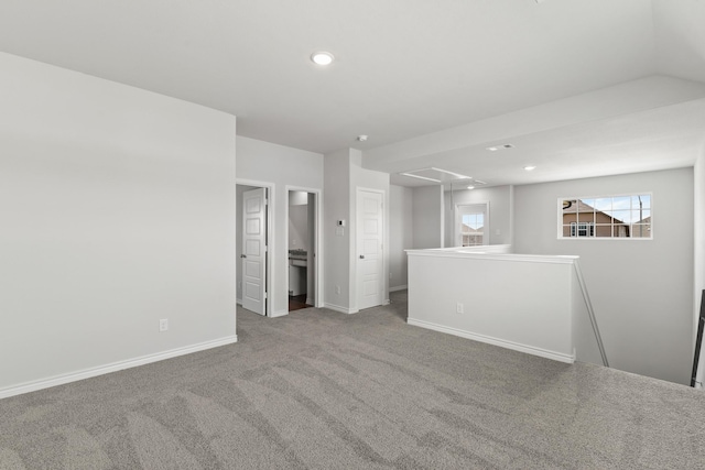 spare room with recessed lighting, carpet, attic access, and baseboards