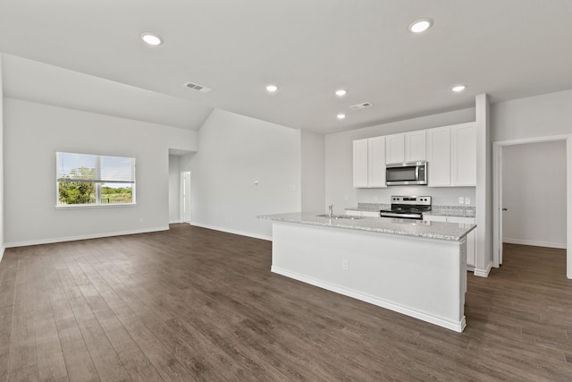 kitchen with a kitchen island with sink, stainless steel appliances, visible vents, light stone countertops, and dark wood finished floors