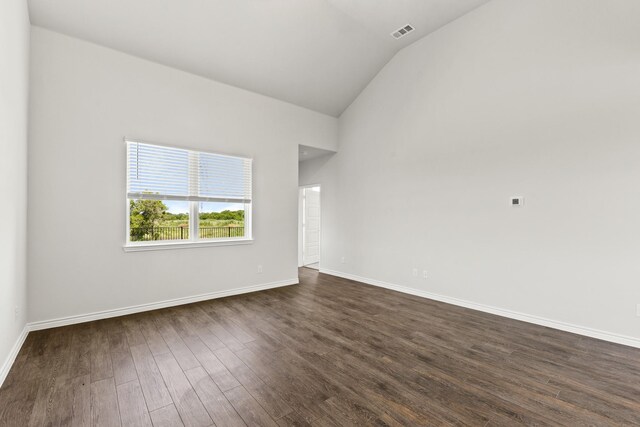 unfurnished room with lofted ceiling and dark hardwood / wood-style floors