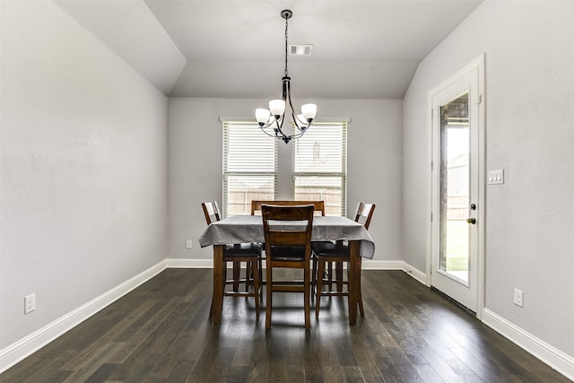 dining area with lofted ceiling, a chandelier, and dark wood-type flooring