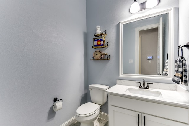 bathroom featuring tile patterned floors, toilet, and vanity