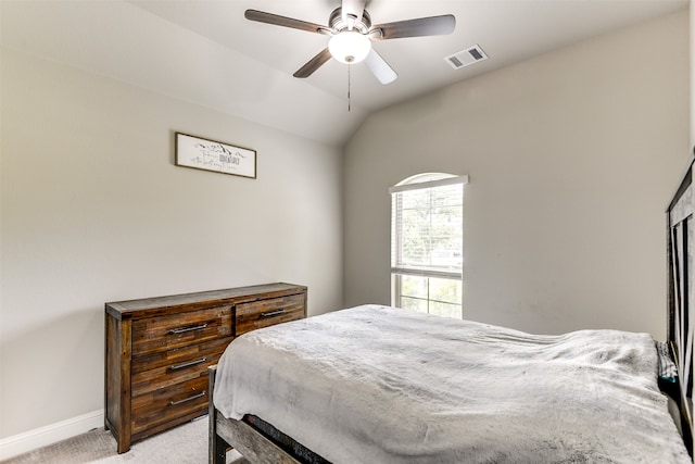 carpeted bedroom with ceiling fan and vaulted ceiling