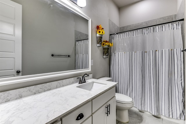 bathroom featuring toilet, tile patterned flooring, and vanity