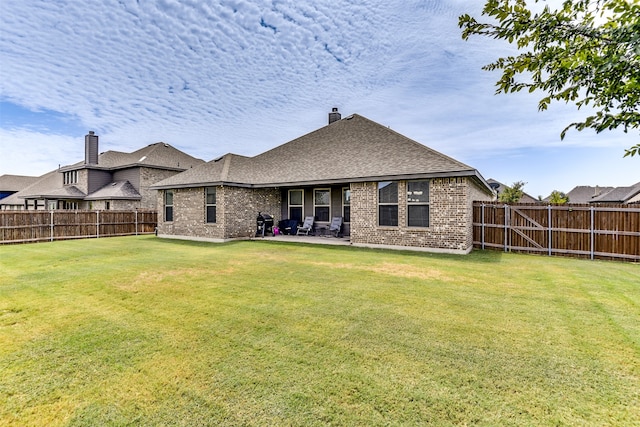 back of property featuring a patio and a lawn