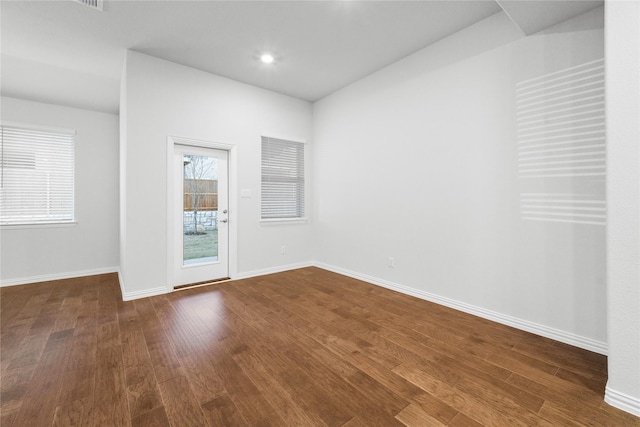 unfurnished room with dark hardwood / wood-style floors