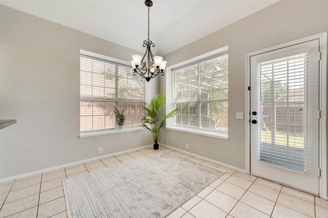 unfurnished dining area featuring light tile patterned floors and an inviting chandelier