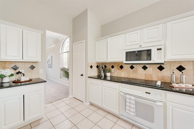 kitchen with white cabinetry and white appliances