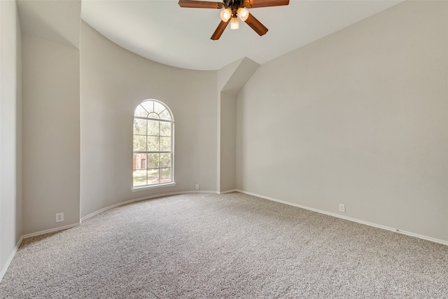 empty room featuring carpet floors, high vaulted ceiling, and ceiling fan