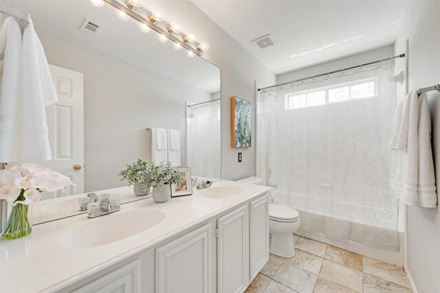 full bathroom featuring vanity, toilet, and shower / tub combo with curtain