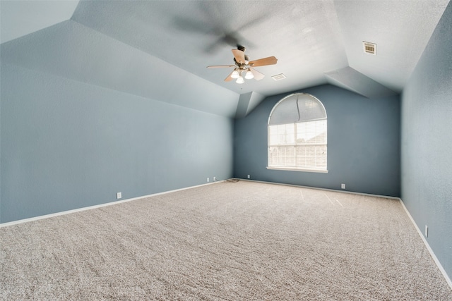 additional living space featuring ceiling fan, a textured ceiling, carpet, and vaulted ceiling