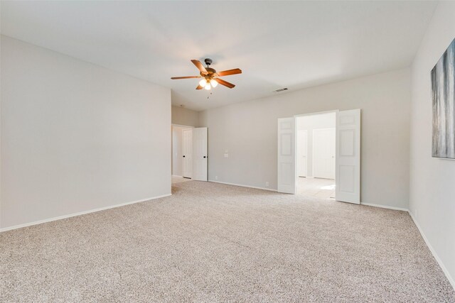 unfurnished room featuring light carpet and ceiling fan