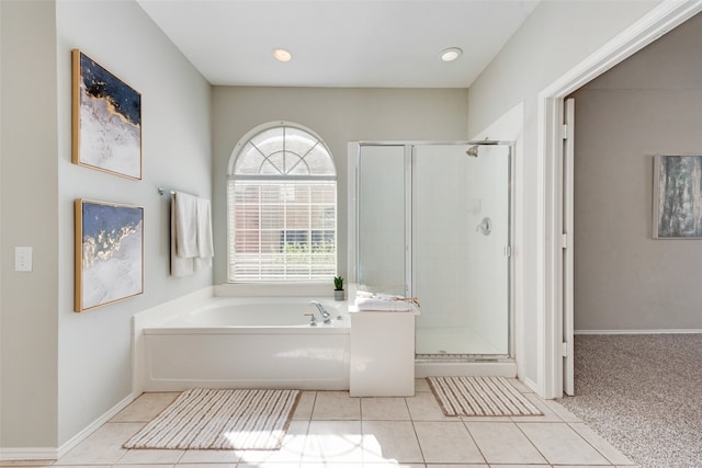 bathroom featuring shower with separate bathtub and tile patterned flooring