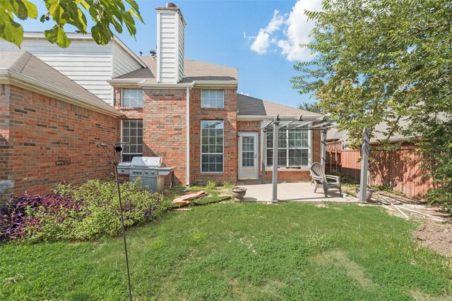 rear view of house featuring a yard and a patio area