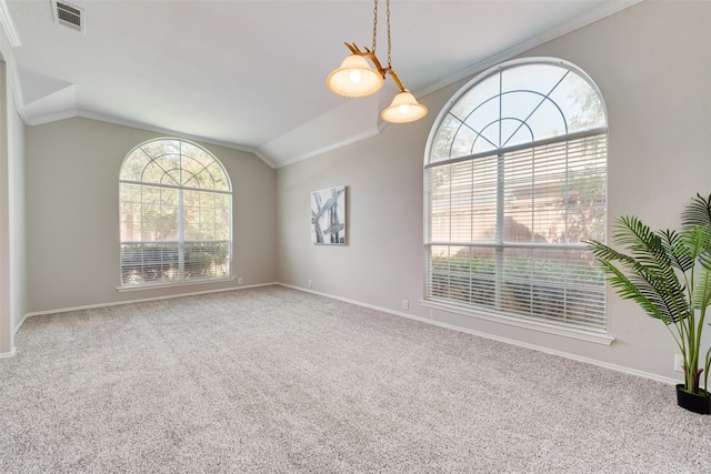 carpeted spare room with ornamental molding and vaulted ceiling