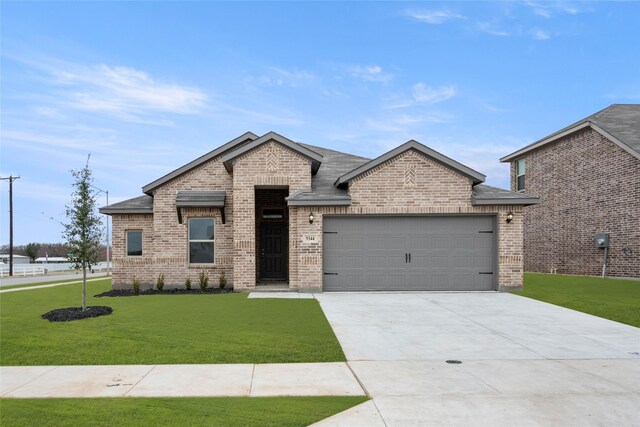 view of front of property featuring a front yard and a garage