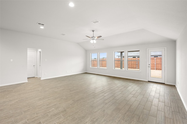 unfurnished room featuring lofted ceiling, light hardwood / wood-style floors, and ceiling fan