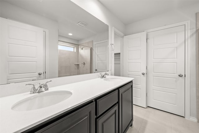 bathroom with tile patterned floors, vanity, and a shower with shower door