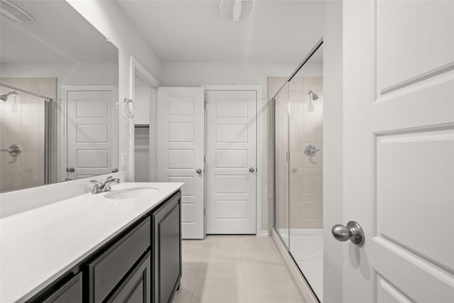 bathroom with vanity, tile patterned flooring, and a shower with door