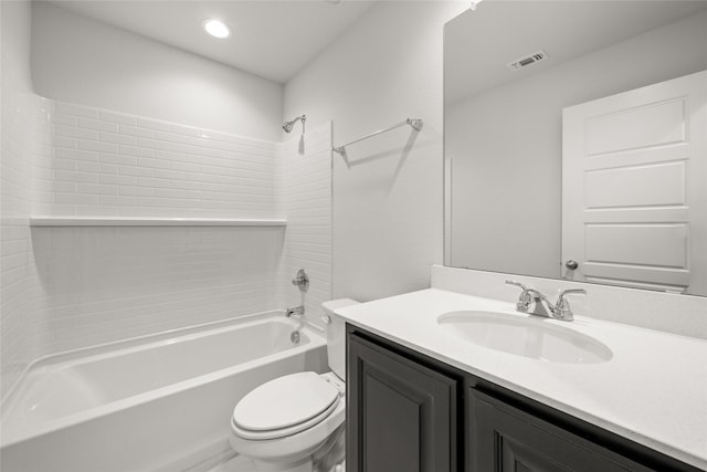 full bathroom with tiled shower / bath, vanity, and toilet