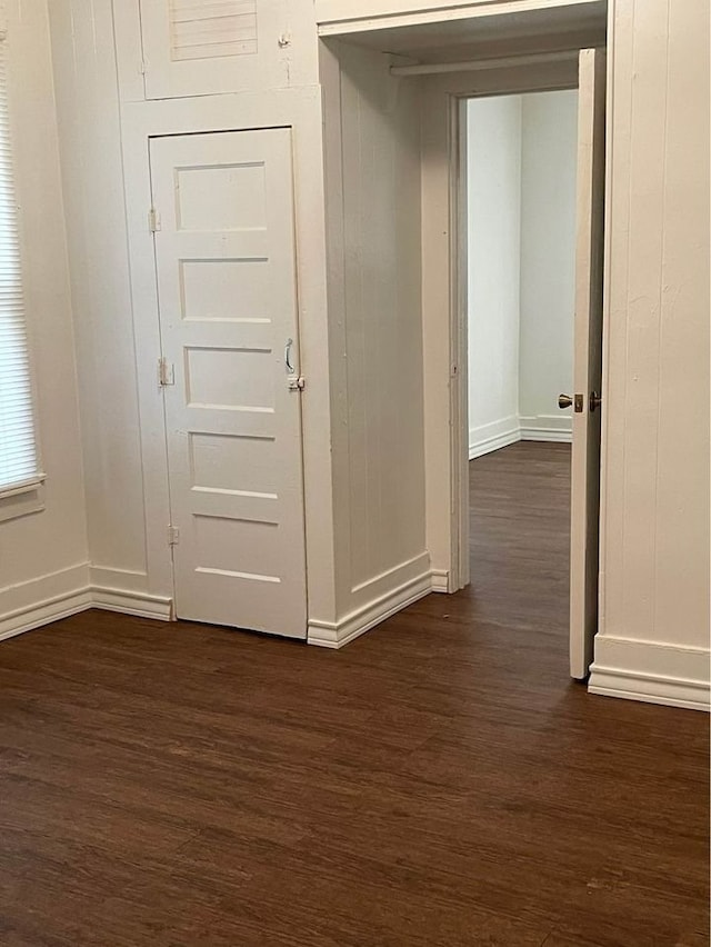 interior space featuring dark wood-style floors and baseboards