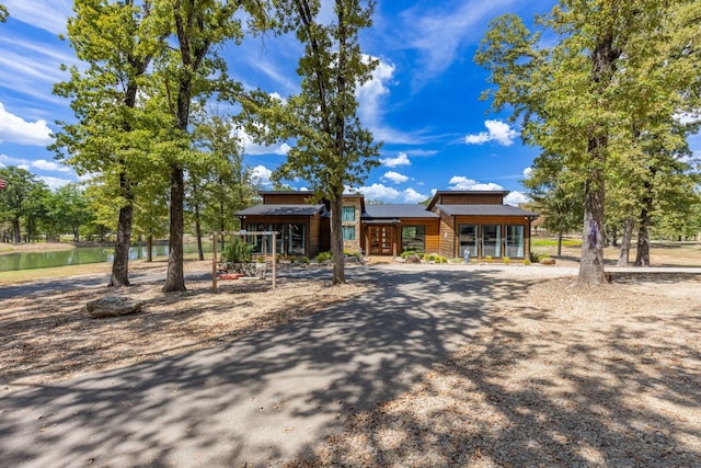 view of front of home with a water view