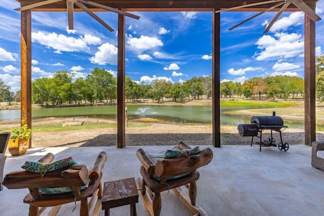 view of patio with a water view and grilling area