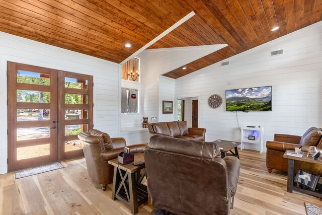 living room featuring french doors, lofted ceiling, wooden ceiling, and light hardwood / wood-style floors