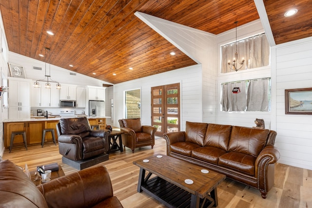 living room with a notable chandelier, light wood-type flooring, wood ceiling, and lofted ceiling