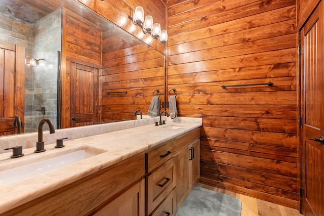 bathroom with vanity and wood walls