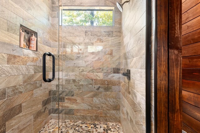 bathroom featuring a shower with door