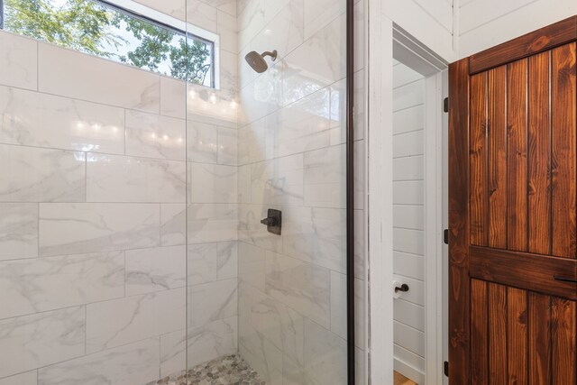 bathroom featuring a shower with door