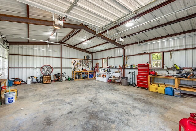 garage with a garage door opener and a workshop area