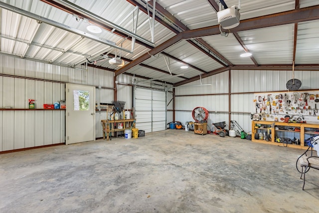 garage featuring a garage door opener and a workshop area