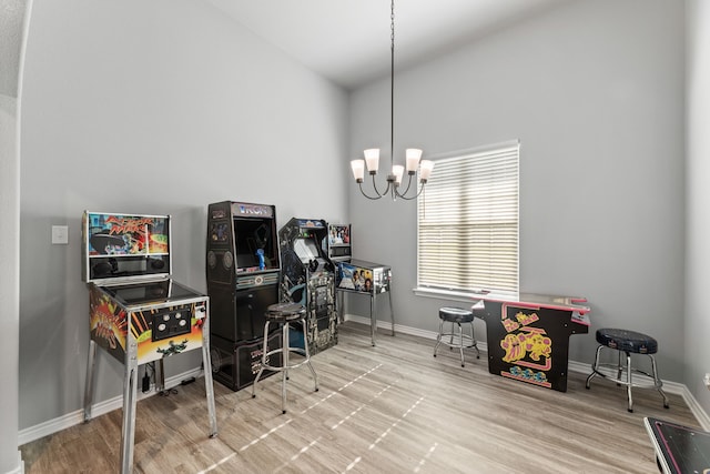 office featuring a towering ceiling, hardwood / wood-style floors, and a chandelier